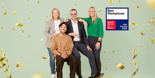 Six people celebrating with confetti next to a Best Workplaces Australia 2025 sign from Great Place to Work